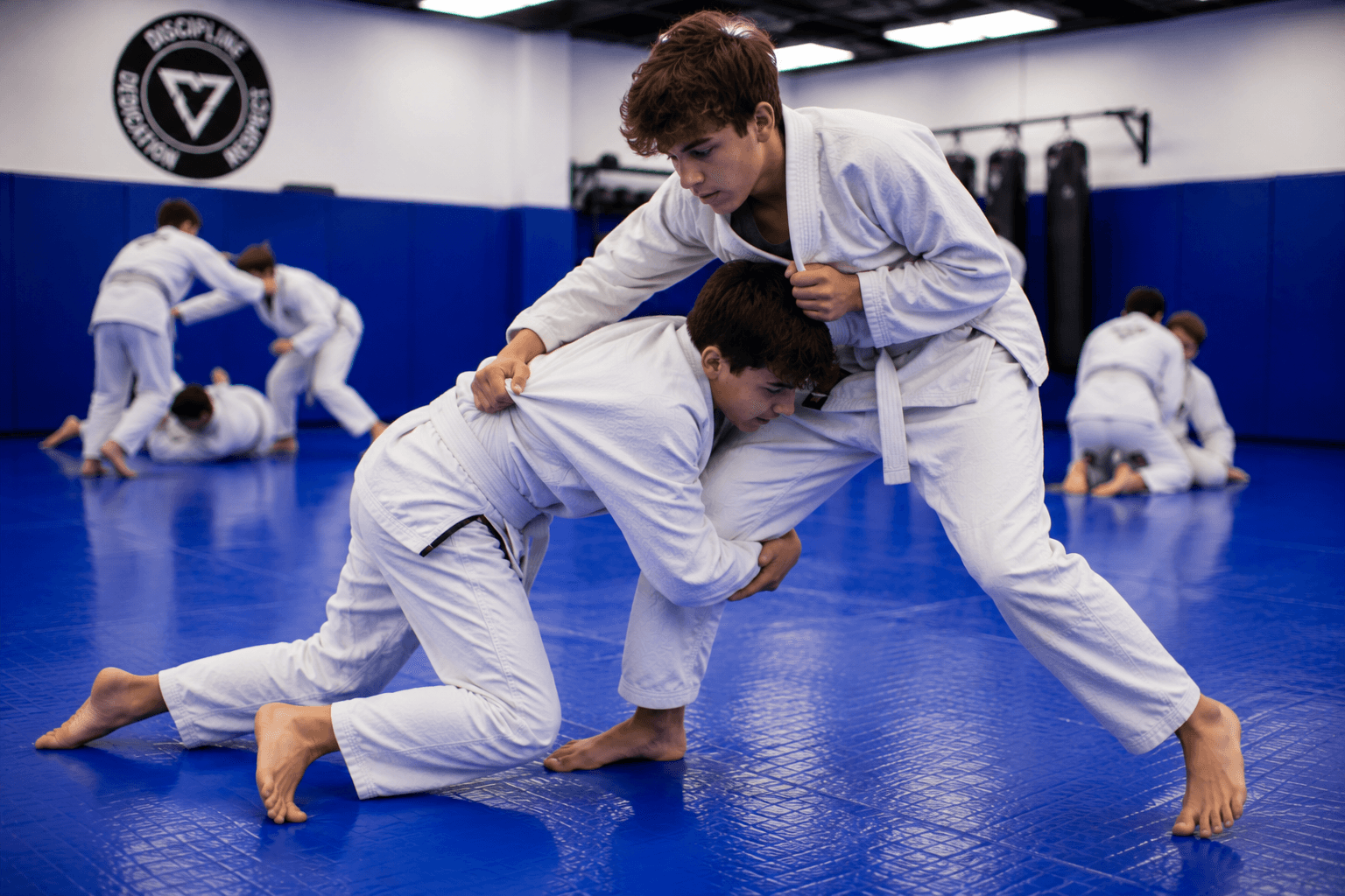 Young students training in boxing gloves during a Teens Brazilian Jiu-Jitsu class at Master Pete's BJJ Academy